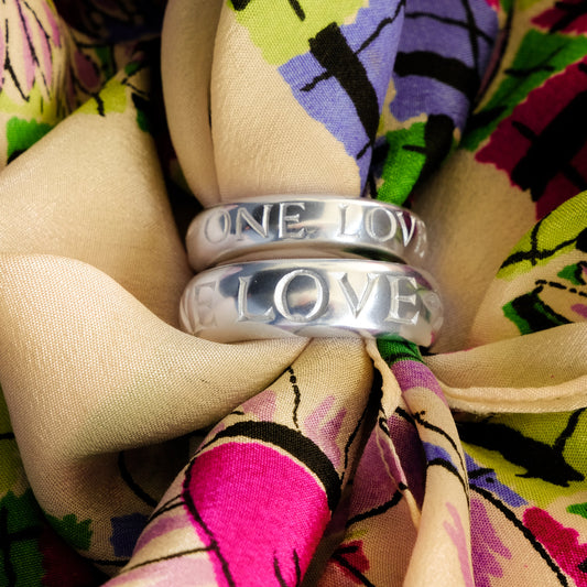 D section band rings with ONE LOVE engraved into the surface