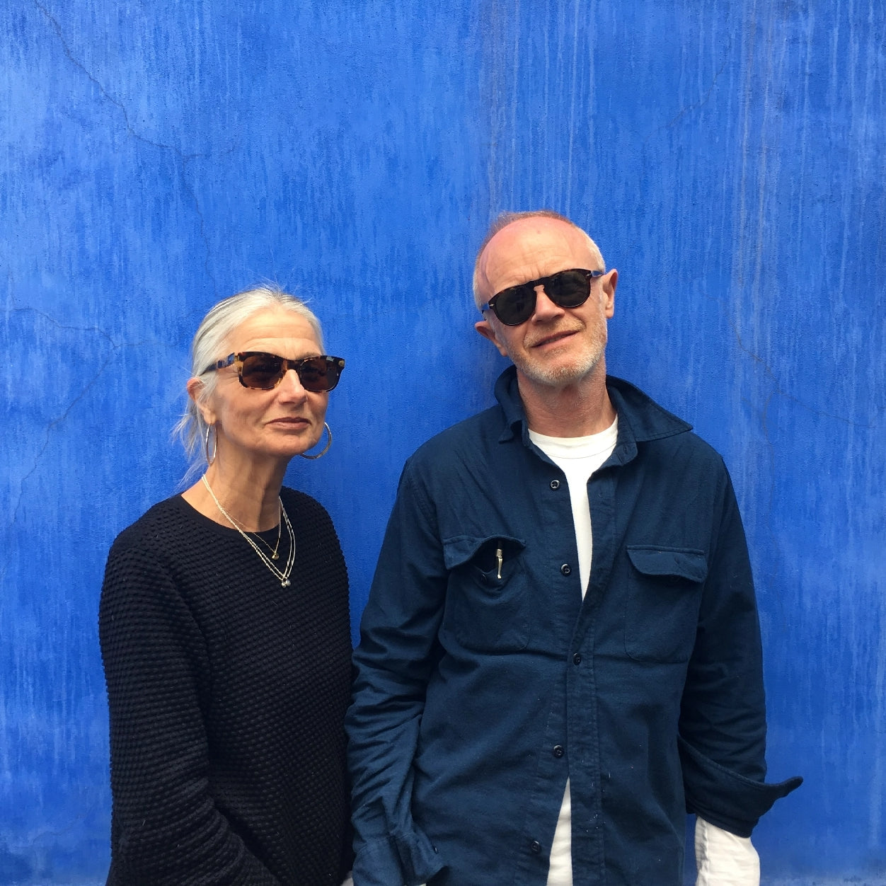 Sheila Teague and Gary Wright. Standing against a blue wall.