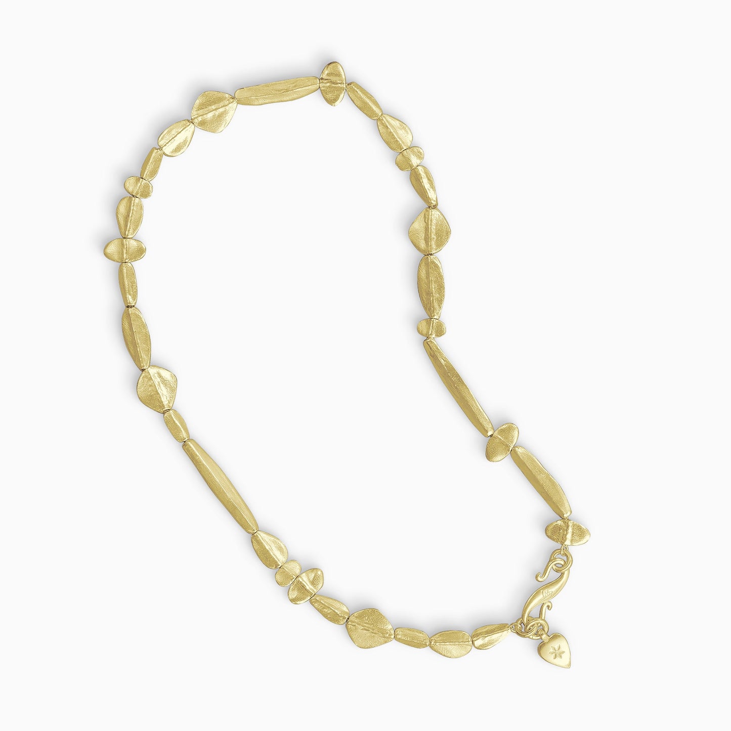A necklace of 18ct Fairtrade yellow gold handmade solid beads reminiscent of the shape of seeds. These vary in size from 6mm x 9mm to 35mm x 13mm and are randomly arranged. The length of the necklace is 45cm. Each bead has a raised section through the centre and tapers out to the edges. Organic and textured, the Calliope beads sit fairly flat to the neck.