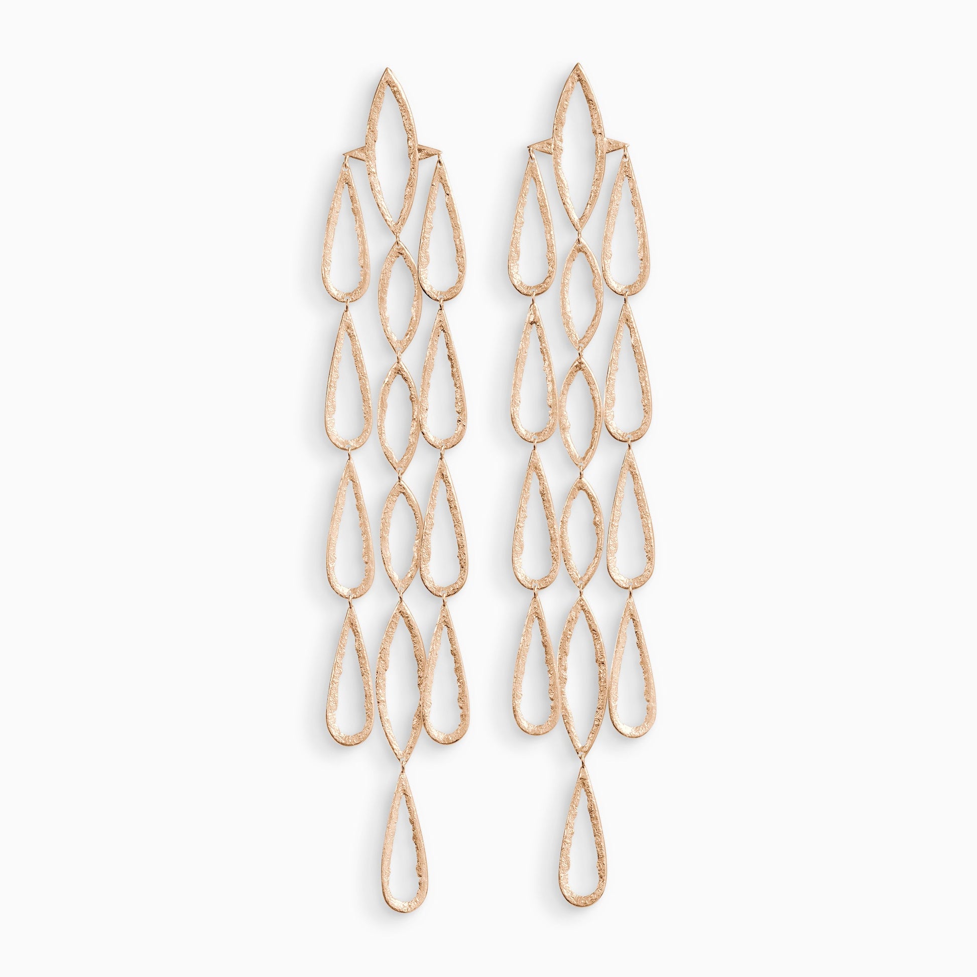 A pair of 18ct Fairtrade rose  gold drop earrings. 3 parallel lines of articulating large teardrop shapes hang from a large lozenge shapes with a stud ear fastening . These open shapes have a strong organic texture and are smooth on the outside edges with fragmented inside edges. 192mm length. 32mm width.