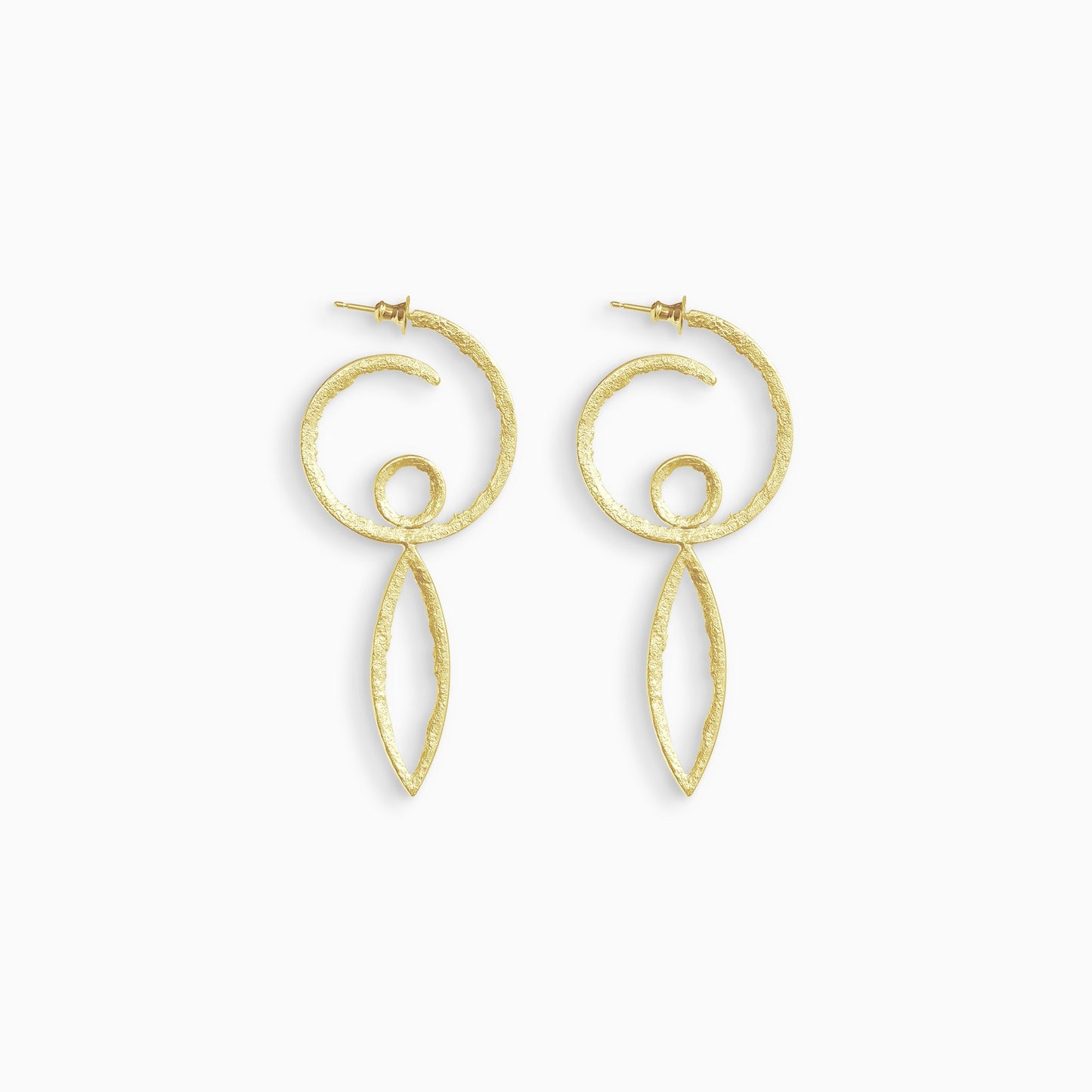 A pair of 18ct Fairtrade yellow gold hoop earrings in the form of a swirl with a stud ear fastening. Inside the bottom of the hoop is a small circle shape and below the hoop there is a long lozenge shape. These open shapes have a strong organic texture and are smooth on the outside edge with fragmented inside edges. 36mm outside diameter.