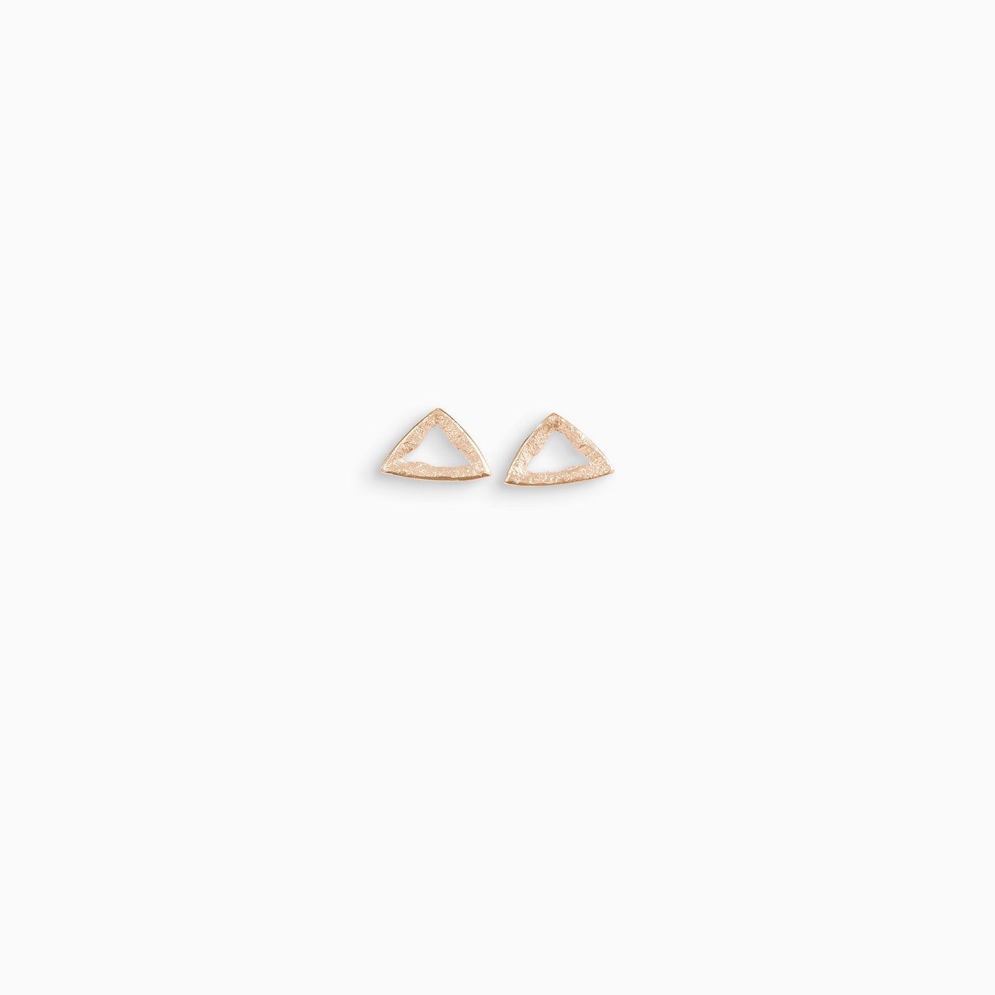 A pair of 18ct Fairtrade rose gold stud earrings, triangular in form with an open centre. Strong organic texture. Smooth outside edge, fragmented inside edges. 14mm x 14mm x14mm 