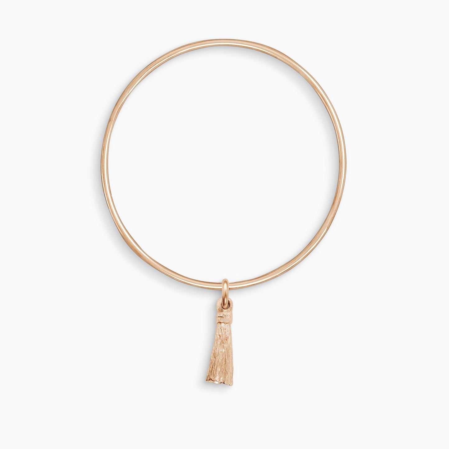 An 18ct Fairtrade rose goldTassel charm, with the texture of an actual tassel, freely moving on a round wire bangle. Charm 25mm. Bangle 63mm inside diameter x 2mm round wire.