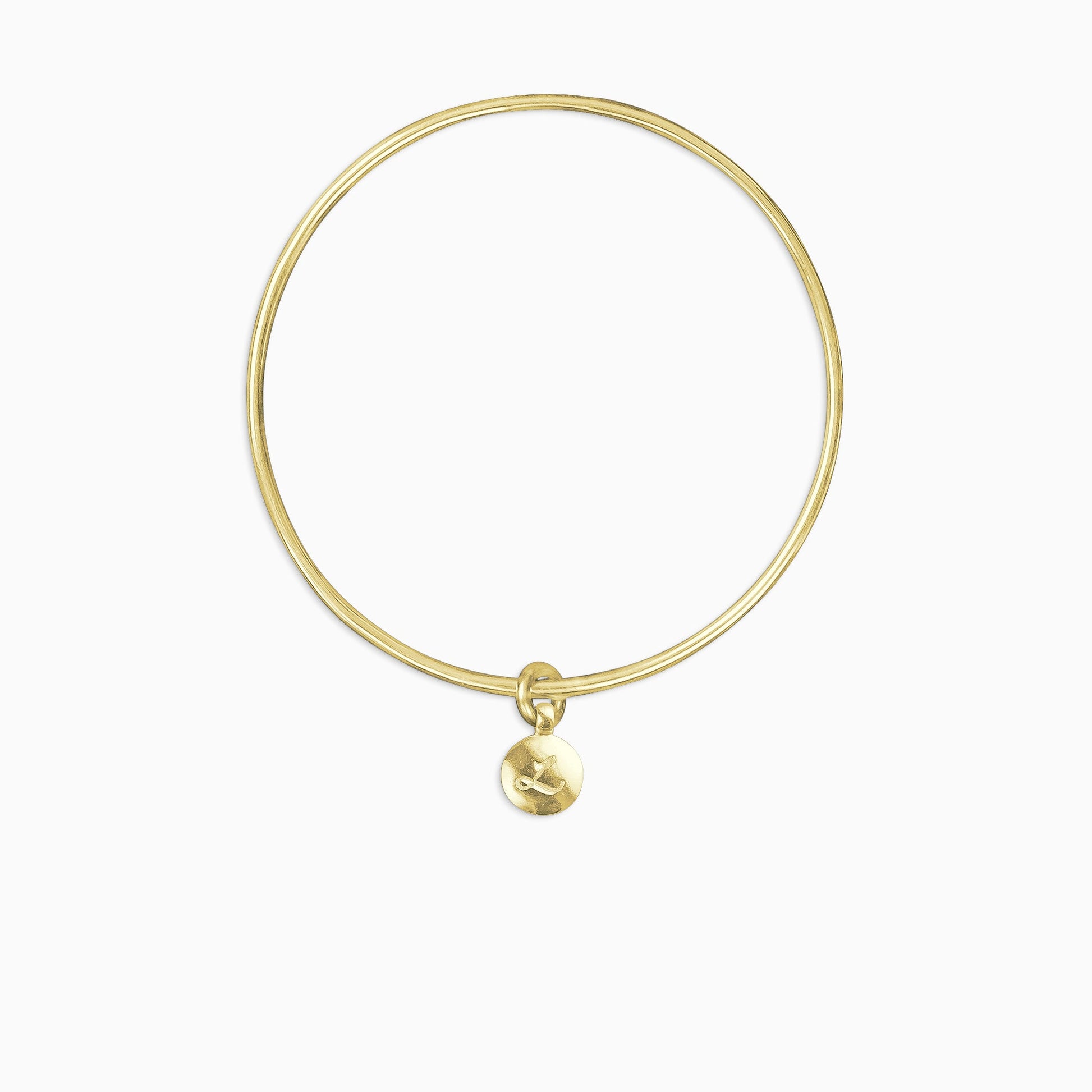An 18ct Fairtrade yellow gold round, smooth charm engraved with a single letter, choose from A-Z, freely moving on a round wire bangle. Charm 13mm diameter. Bangle 63mm inside diameter x 2mm round wire.