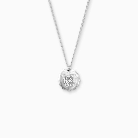 Recycled Silver round 22mm diameter charm on a 45cm fine curb chain. The pendant is smooth with a wavy outside edge. Amor Vincit Om, the Medieval Latin for Love Conquers All  is inscribed on the front in a Copperplate script. 