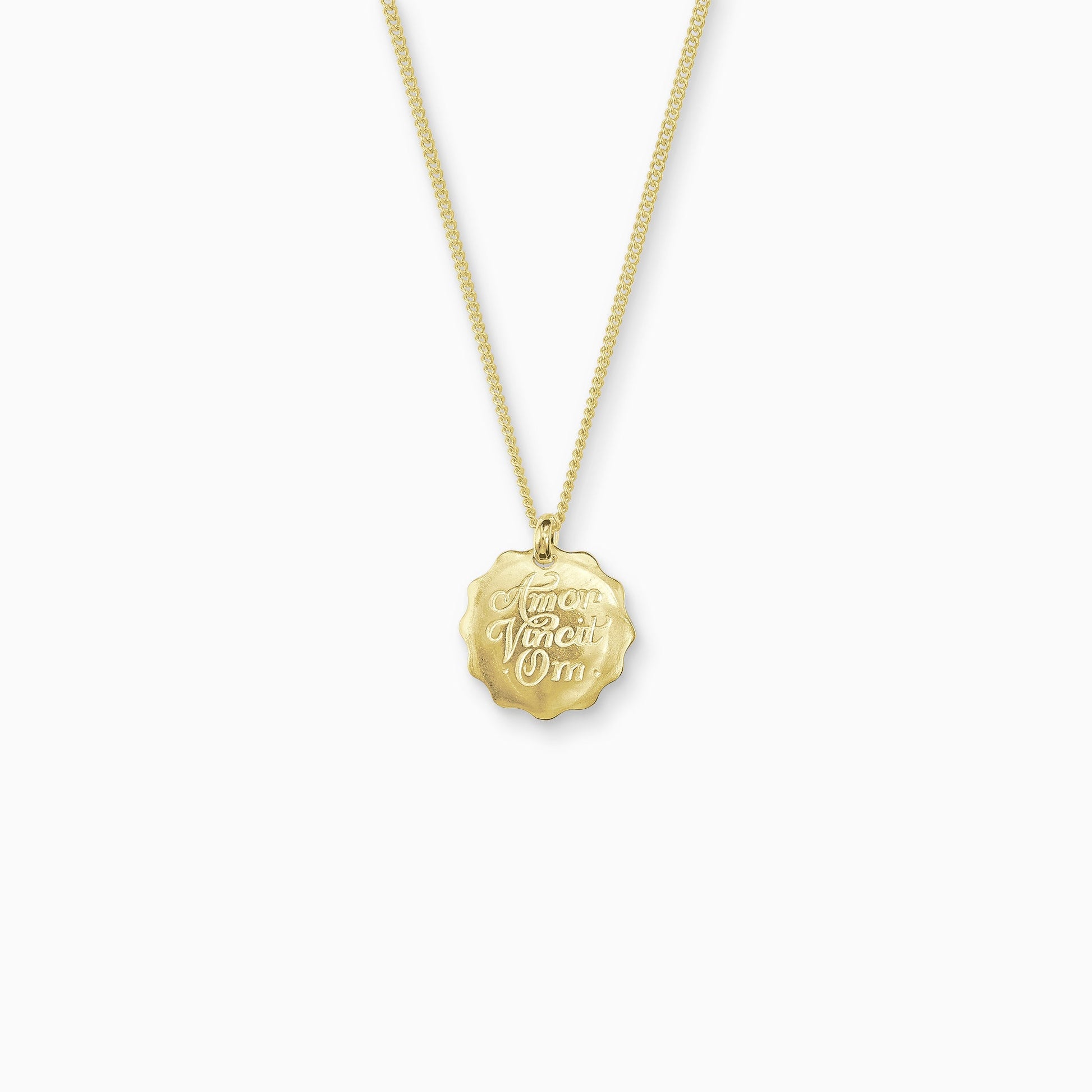 18ct Fairtrade yellow gold round 22mm diameter charm on a 45cm fine curb chain. The pendant is smooth with a wavy outside edge. Amor Vincit Om, the Medieval Latin for Love Conquers All  is inscribed on the front in a Copperplate script. 
