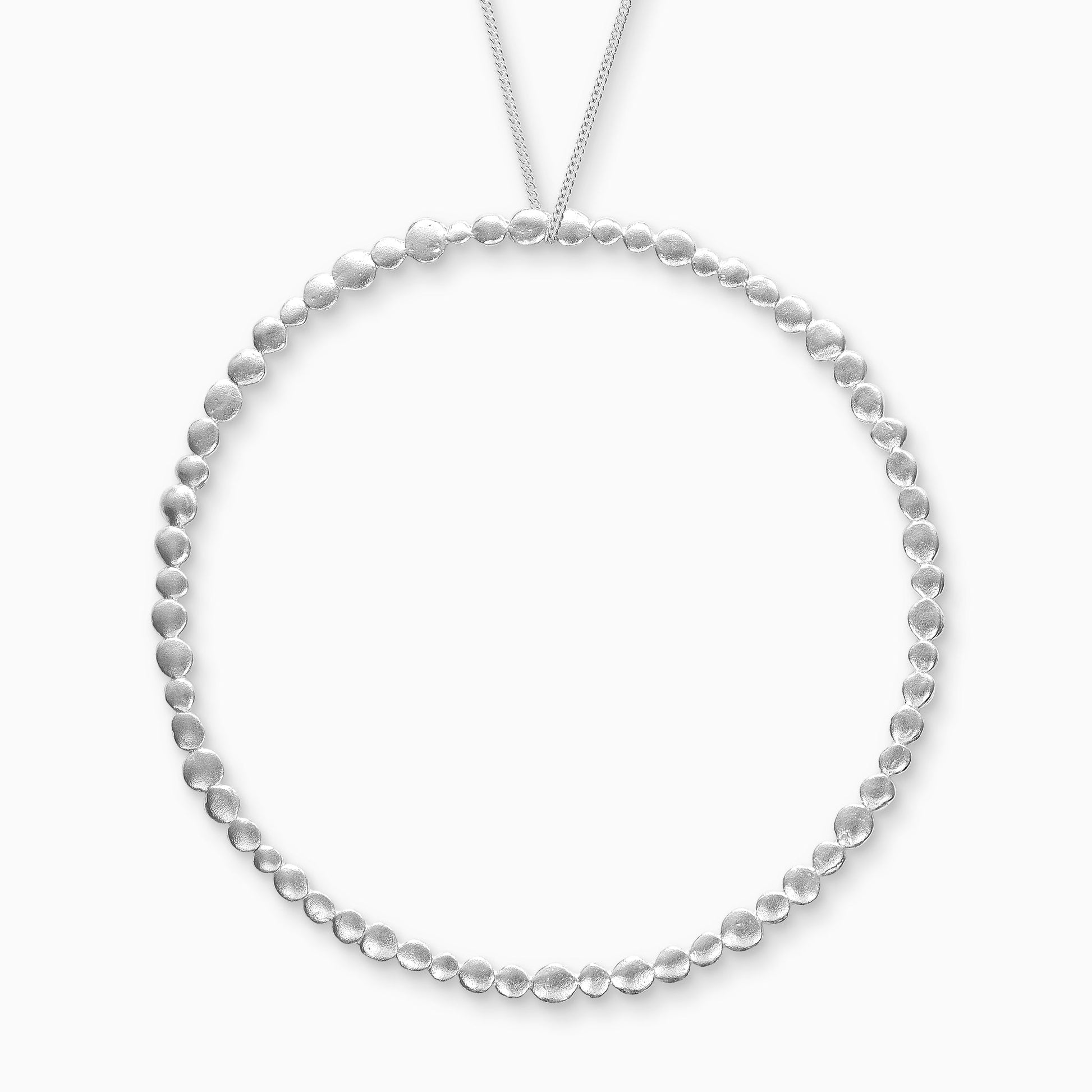 Recycled Silver pendant. A line of dainty textured dots of silver in varying sizes create a circular pendant 90mm in diameter.
