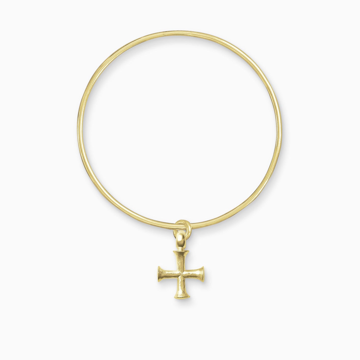 An 18ct Fairtrade yellow gold geometric cross charm freely moving on a round wire bangle. The cross has equal length arms with outward spreading ends.  Charm 25mm. Bangle, 63mm inside diameter x 2mm round wire.