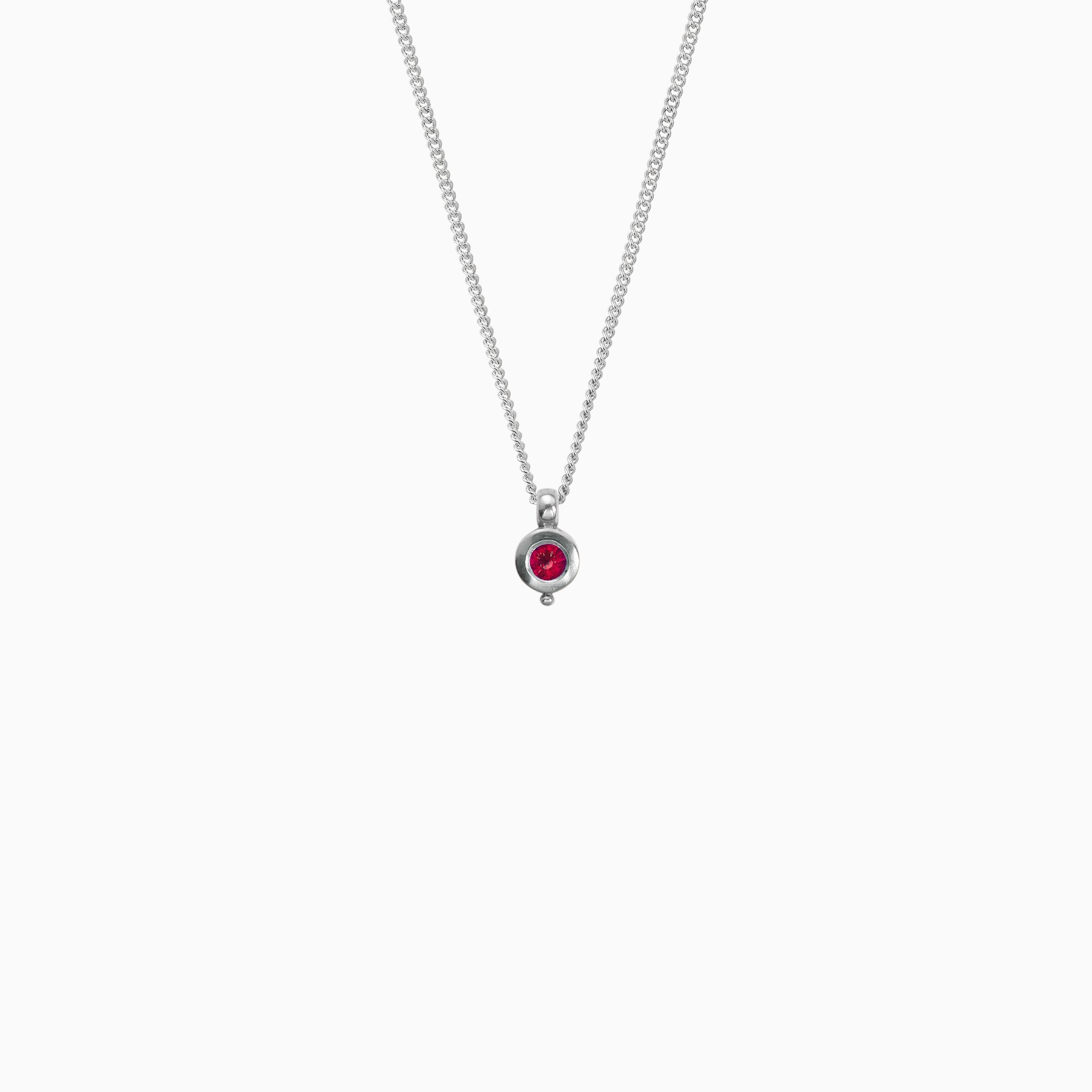 Recycled platinum round pendant 12mm  x 7mm with small round bead attached below on a 45cm fine curb chain. Set with a 4mm round ruby.