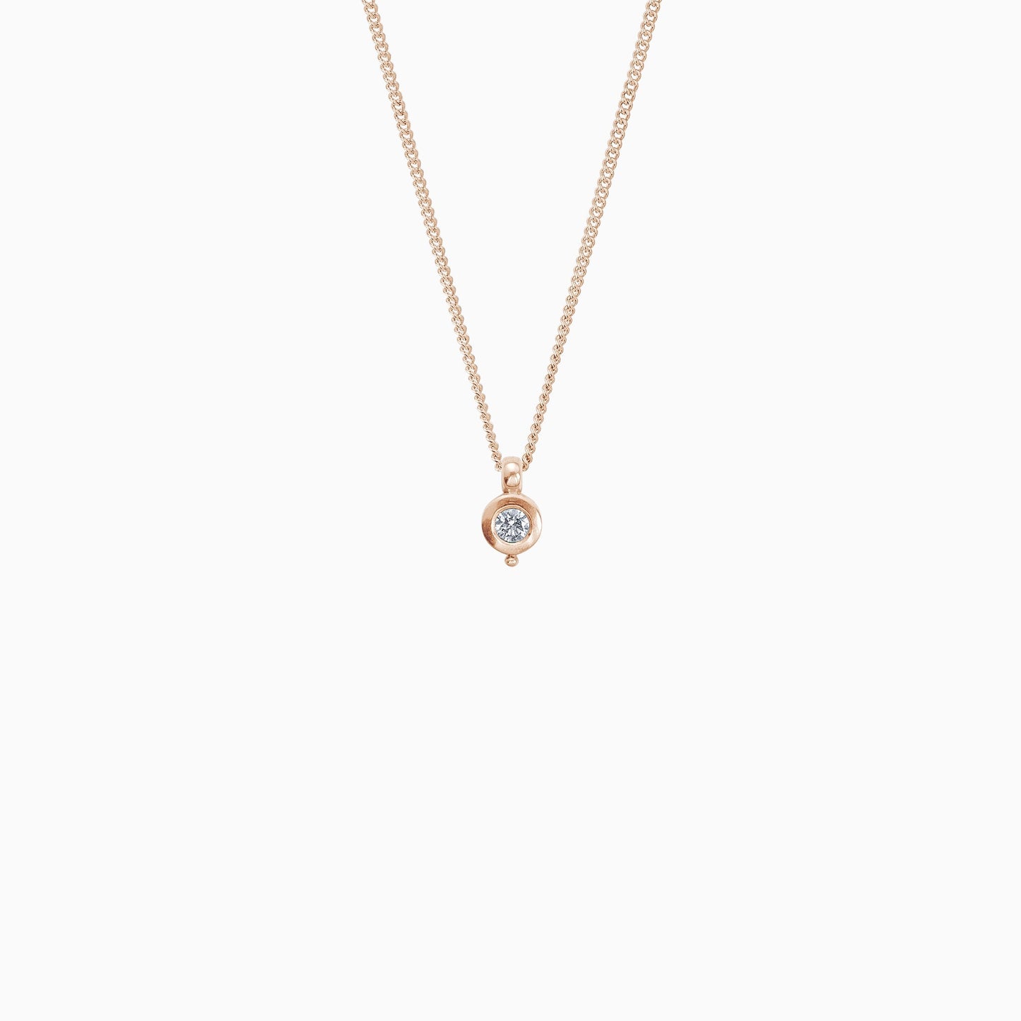 18ct Fairtrade rose gold round pendant 12mm  x 7mm with small round bead attached below on a 45cm fine curb chain. Set with a 0.25ct round diamond.
