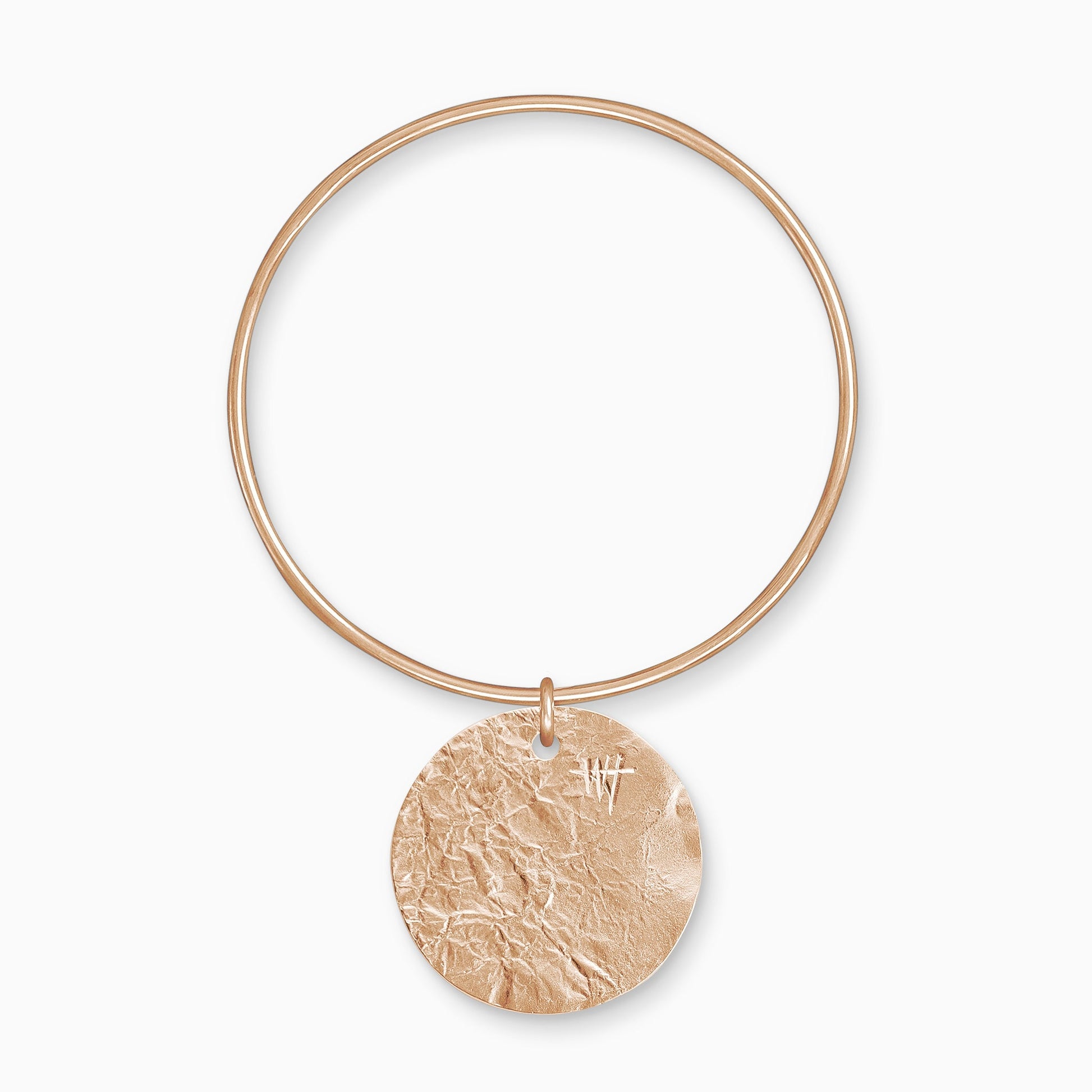 An 18ct Fairtrade rose gold Textured, circular, flat disc charm freely moving on a round wire bangle. Charm 35mm. Bangle 63mm x 2mm.