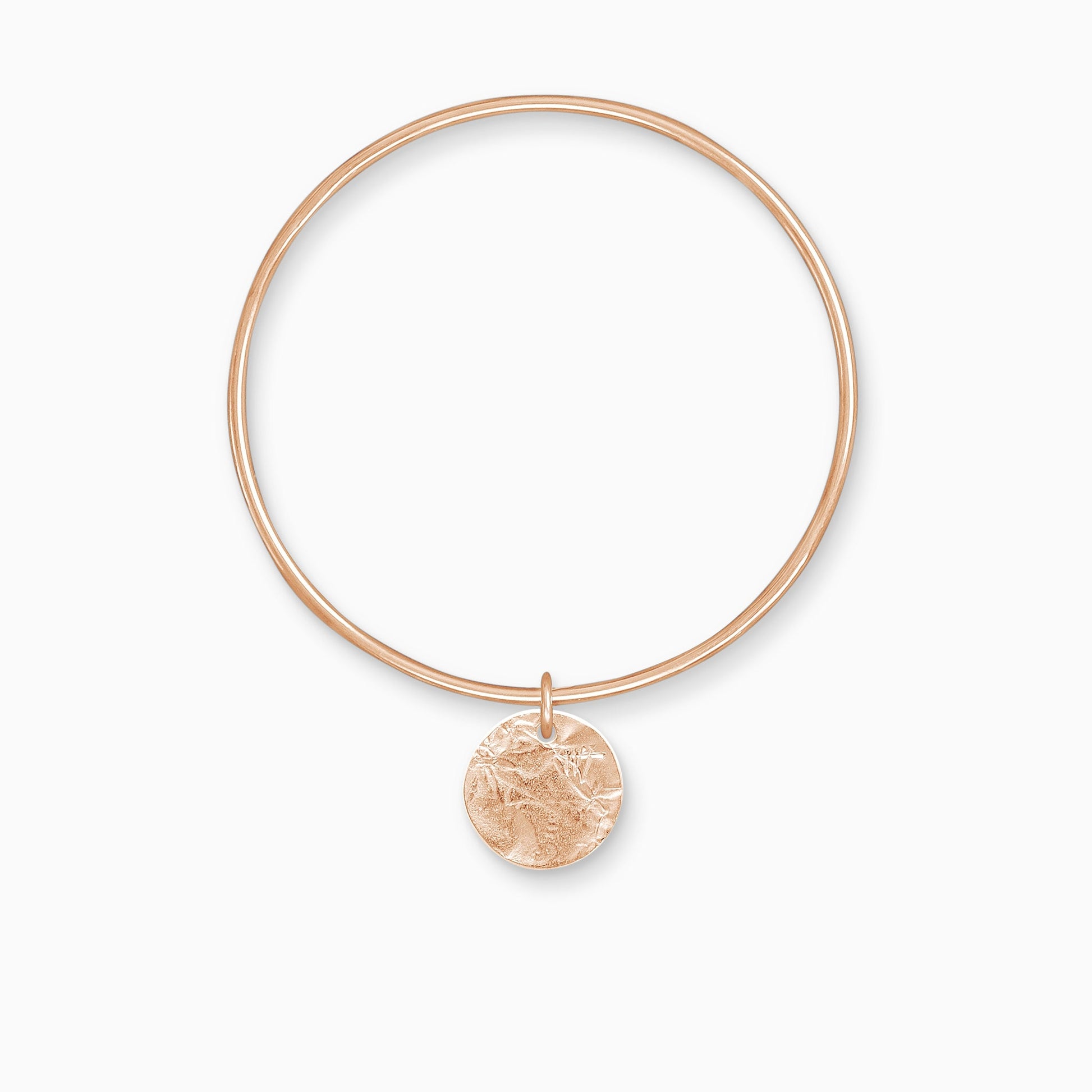 An 18ct Fairtrade rose gold textured, circular, flat disc charm freely moving on a round wire bangle. Charm 17mm. Bangle 63mm inside diameter x 2mm round wire.