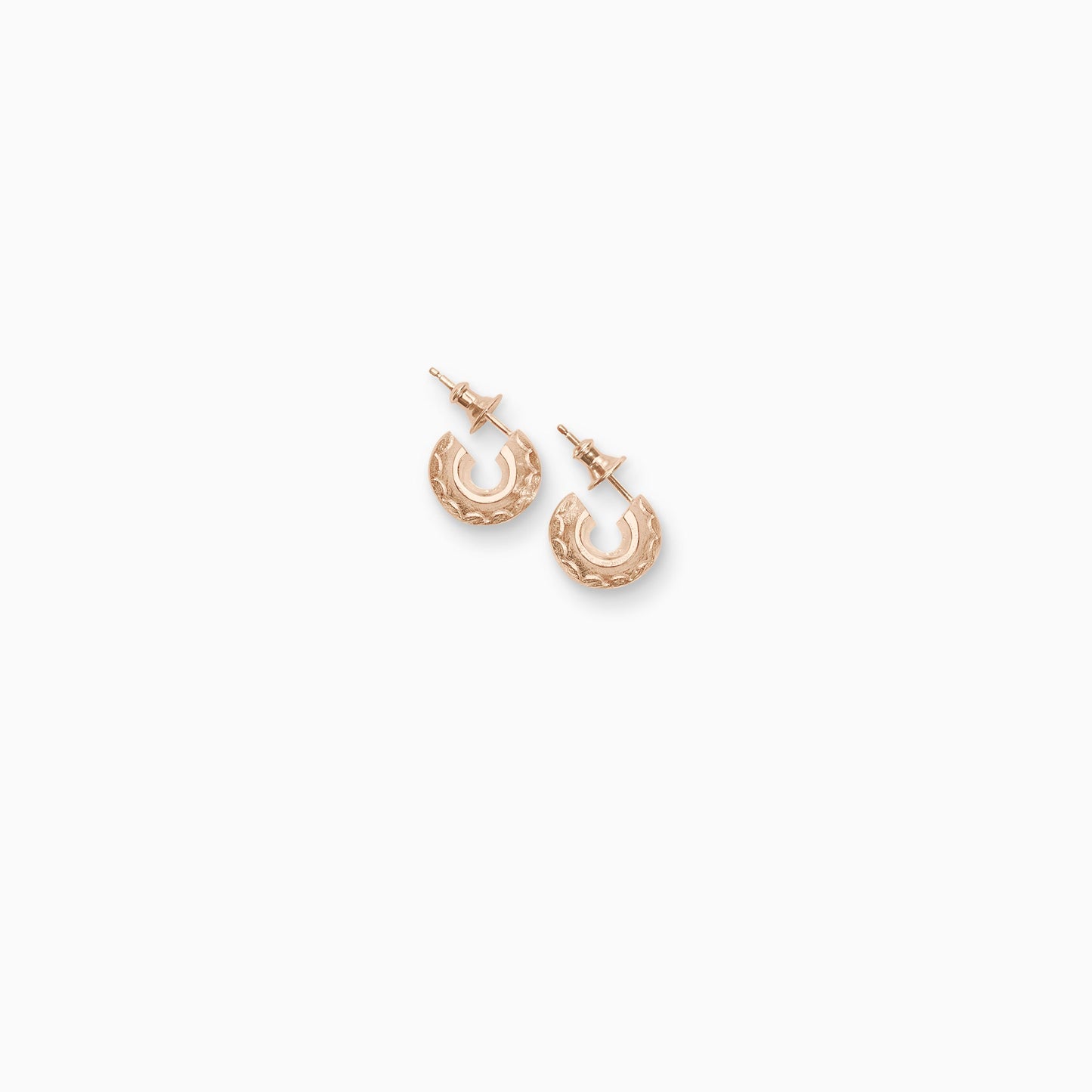 A pair of 18ct Fairtrade rose gold  round hoop earrings with a stud fastening. Sitting snug to the ear with a scalloped pattern engraved around the outer edge. 14mm outside diameter.