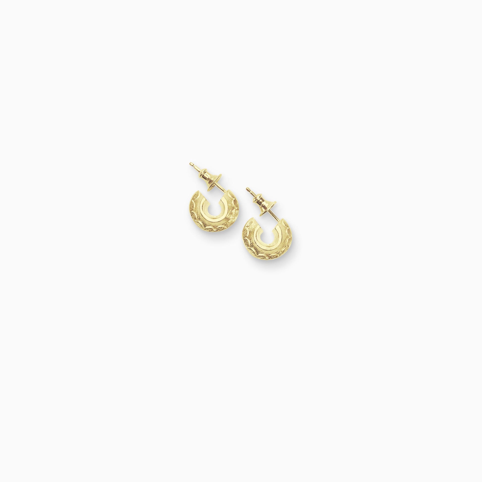 A pair of 18ct Fairtrade yellow gold round hoop earrings with a stud fastening. Sitting snug to the ear with a scalloped pattern engraved around the outer edge. 14mm outside diameter.