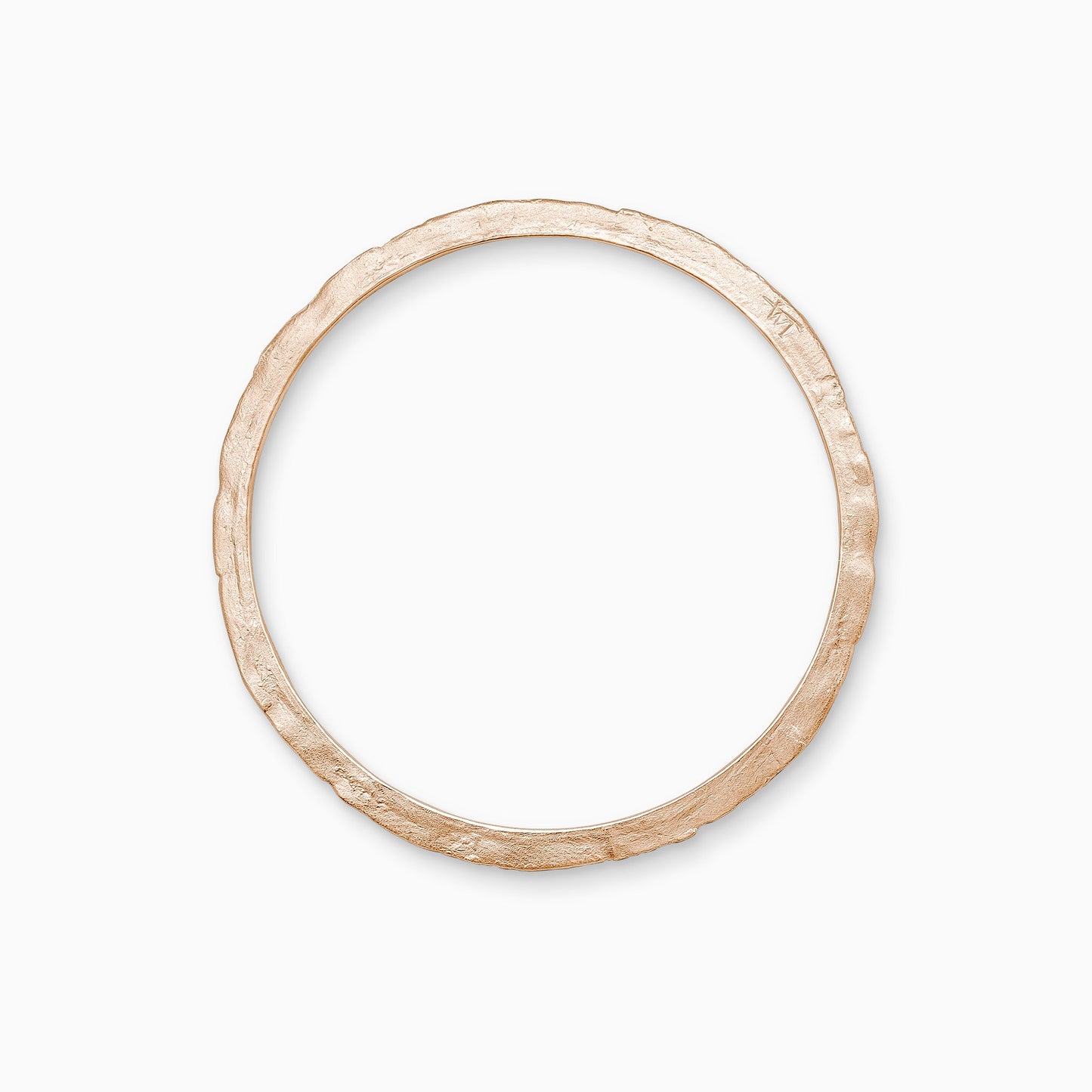 An 18ct Fairtrade rose gold bangle, textured and flat with smooth inside edge and contoured outer edge. Inside diameter 63mm. Outside diameter 72mm.