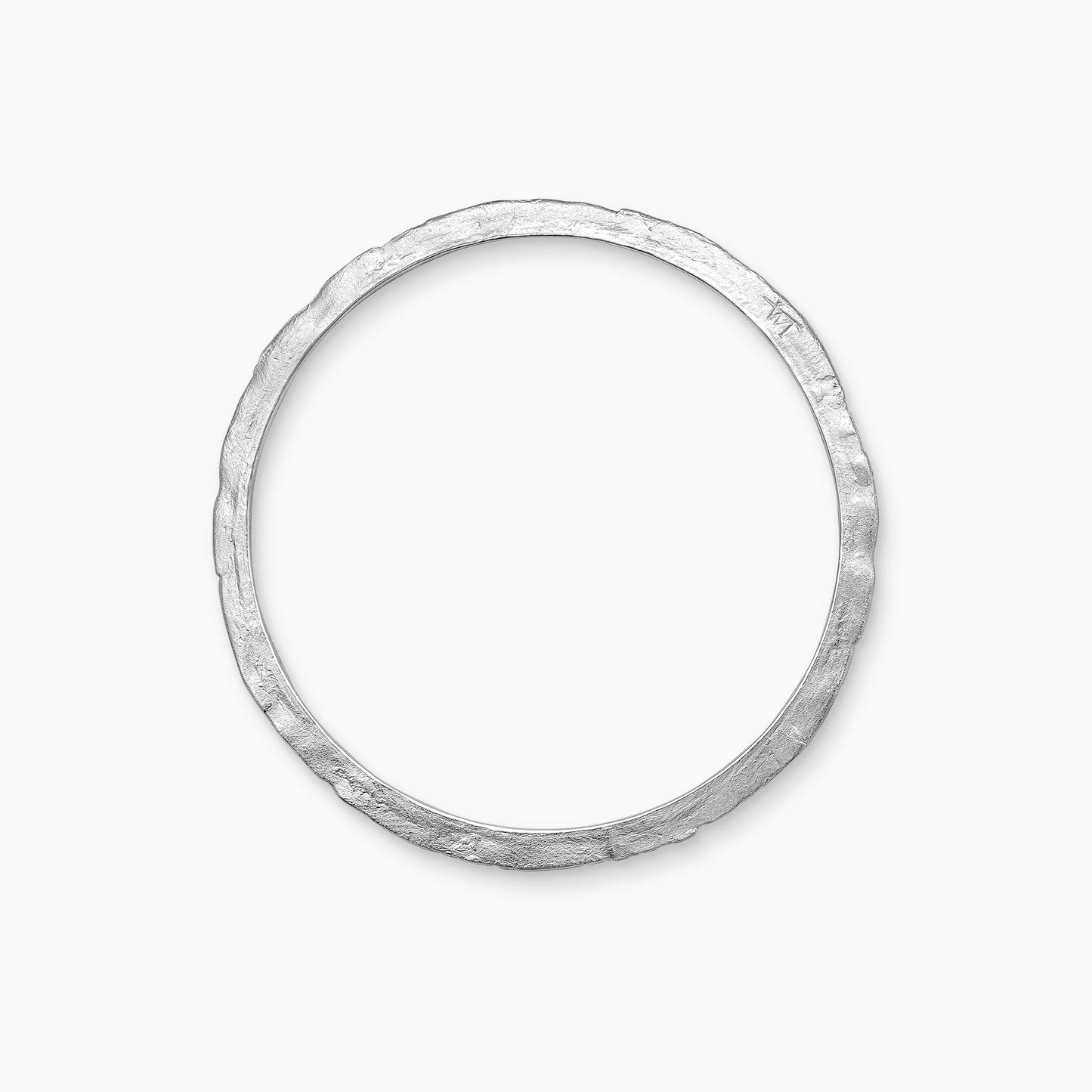 A recycled Silver bangle, textured and flat with smooth inside edge and contoured outer edge. Inside diameter 63mm. Outside diameter 72mm.