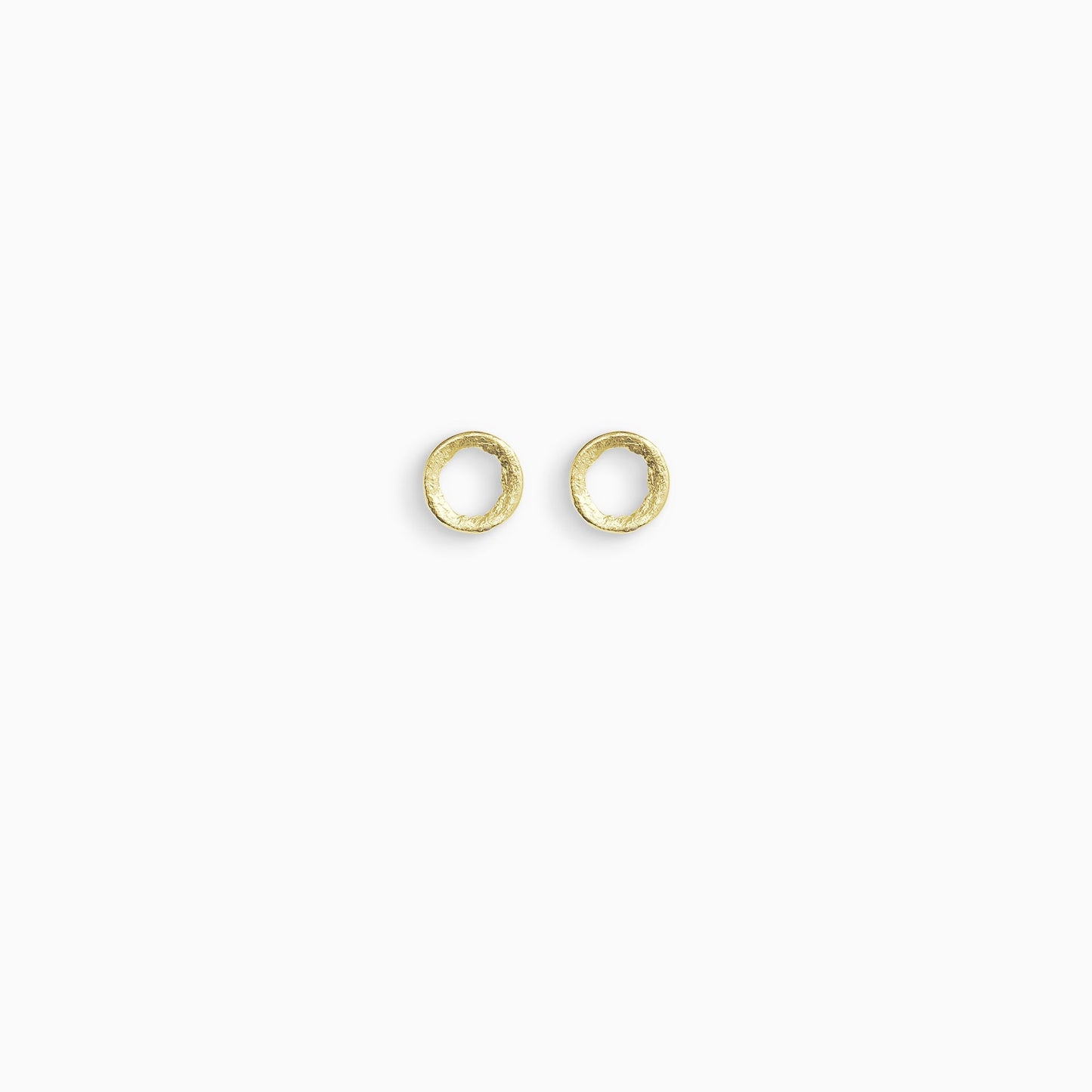 A pair of 18ct Fairtrade yellow gold stud earrings, round in form with an open centre. Strong organic texture. Smooth outside edge, fragmented inside edges. 11mm outside diameter.