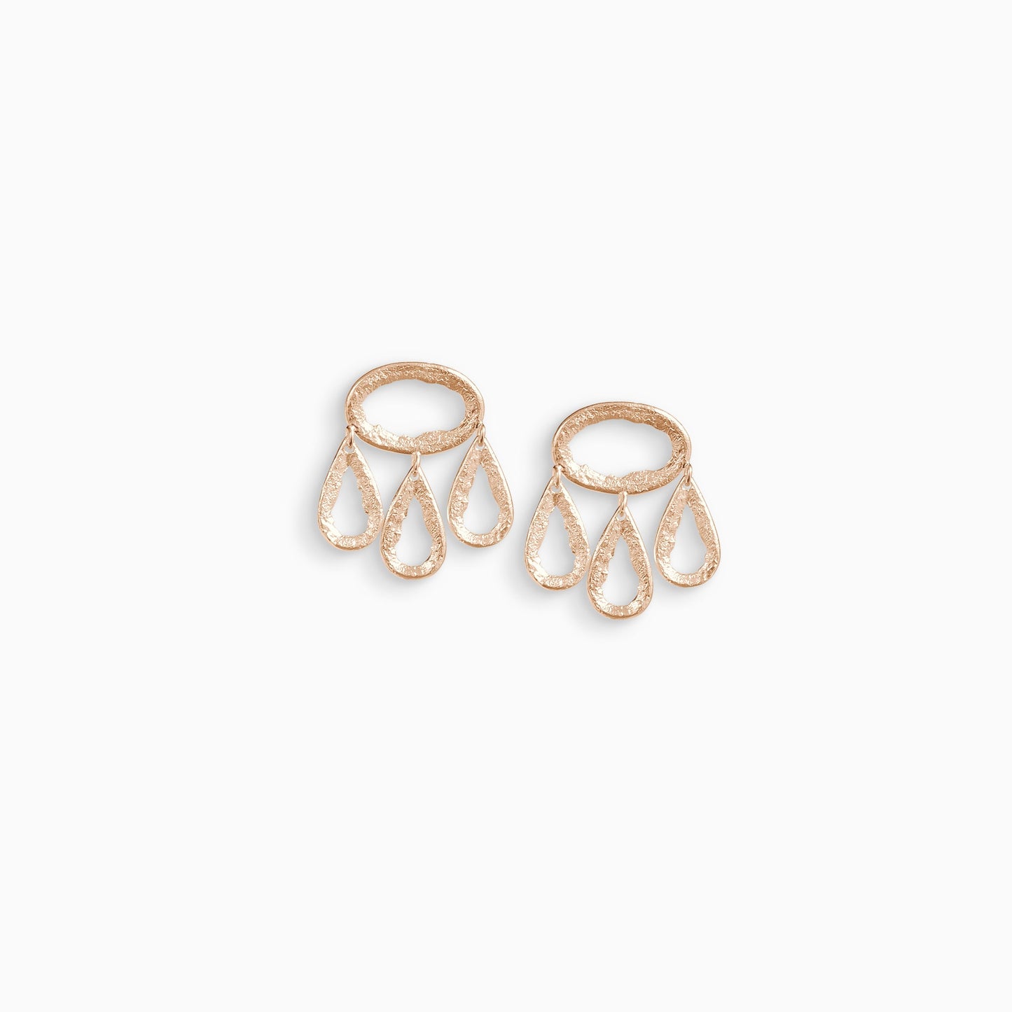A pair of 18ct Fairtrade rose gold drop earrings. 3 articulating small teardrop shapes hang hang from a horizontal oval shape with a stud ear fastening. These open shapes have a strong organic texture and are smooth on the outside edges with fragmented inside edges. 28mm length. 25mm width.