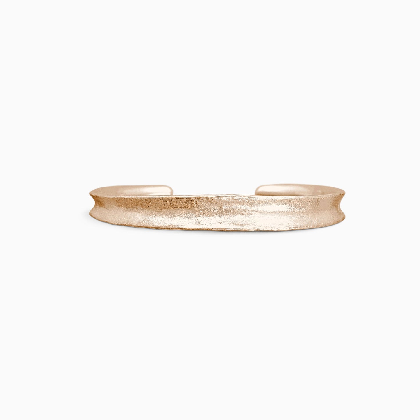 An 18ct Fairtrade rose gold Cuff bangle fitting close to wrist. Concave and textured. Open ended to get on and off. Width 8mm. Inside oval diameter 65mm.