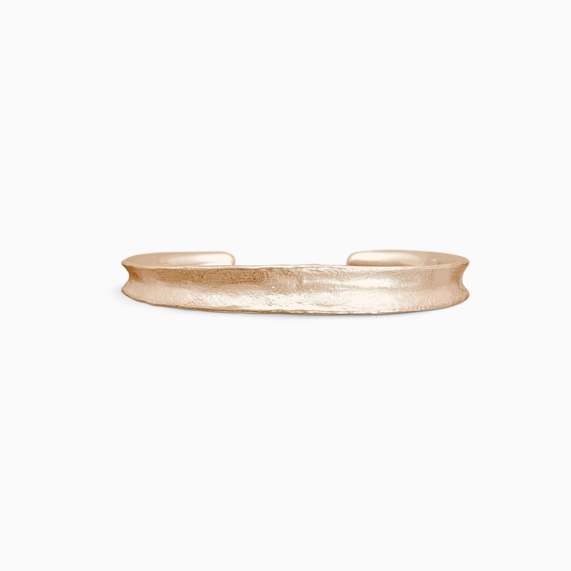 An 18ct Fairtrade rose gold Cuff bangle fitting close to wrist. Concave and textured. Open ended to get on and off. Width 8mm. Inside oval diameter 58mm. 