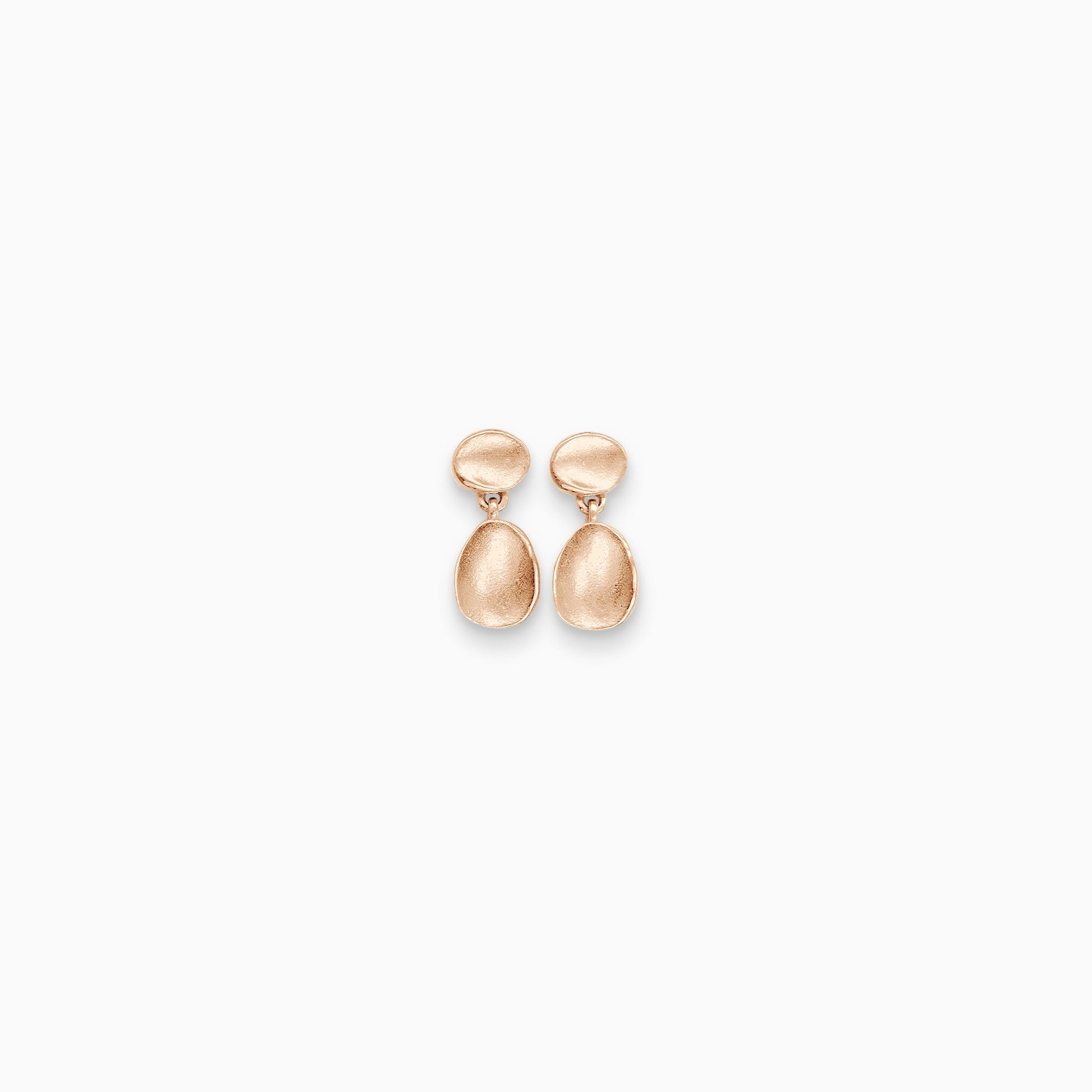 A pair of 18ct Fairtrade rose gold small earrings, a dainty concave oval disc has an stud ear fastening and hanging below is another slightly larger oval disc. Satin finish. 15mm length, 6mm width
