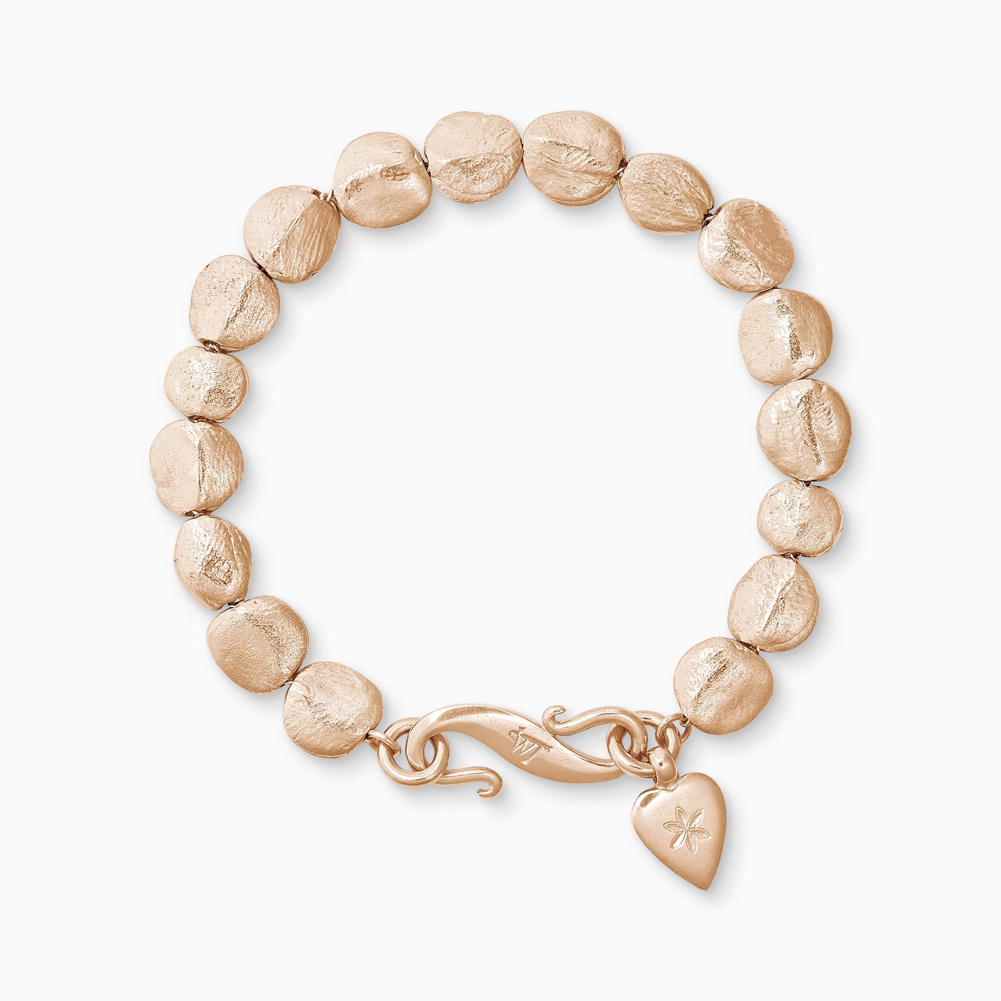 An 18ct Fairtrade rose gold bracelet of handmade textured beads with a smooth heart shaped charm engraved with a 6 petal flower and our signature ’S’ clasp. Bracelet length 190mm. Beads varying from approximately 7mm x 4mm to 10mm x 11mm
