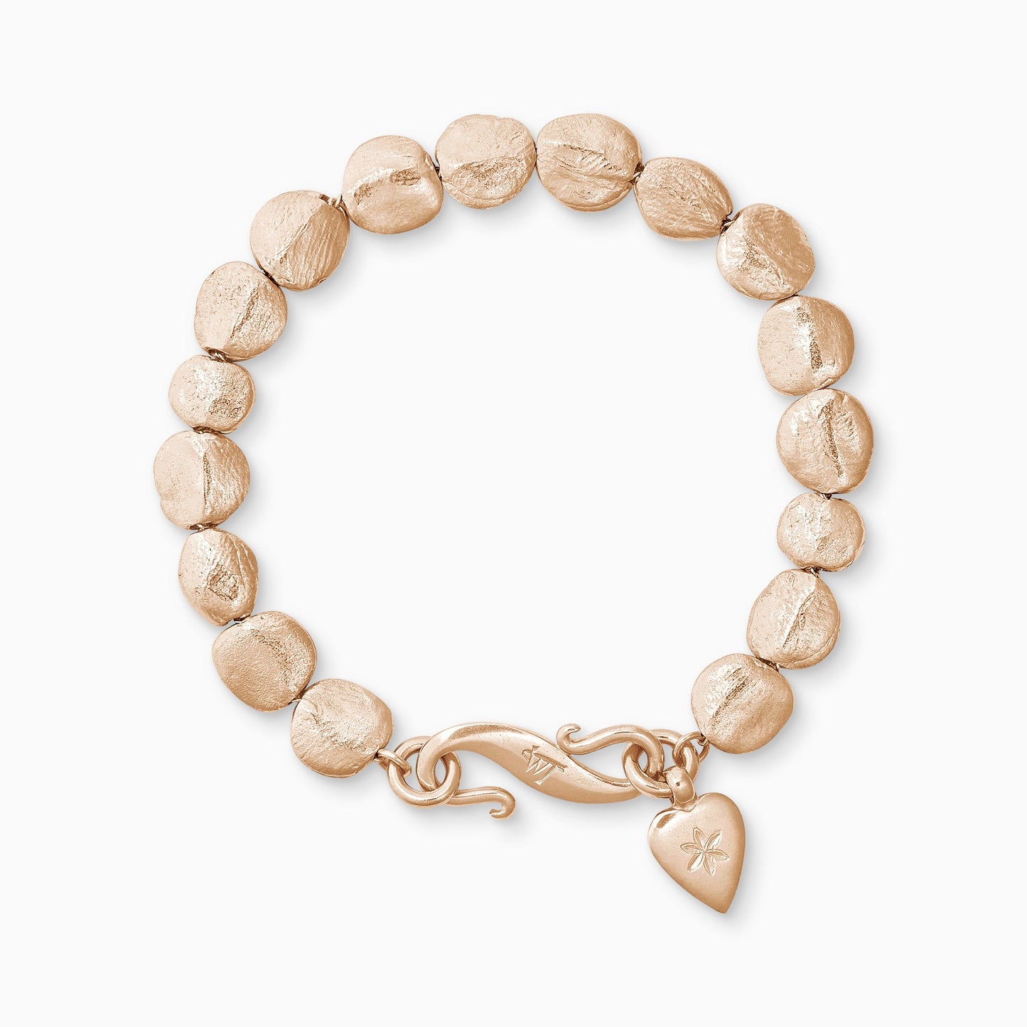 An 18ct Fairtrade rose gold bracelet of handmade textured beads with a smooth heart shaped charm engraved with a 6 petal flower and our signature ’S’ clasp. Bracelet length 210mm. Beads varying from approximately 7mm x 4mm to 10mm x 11mm