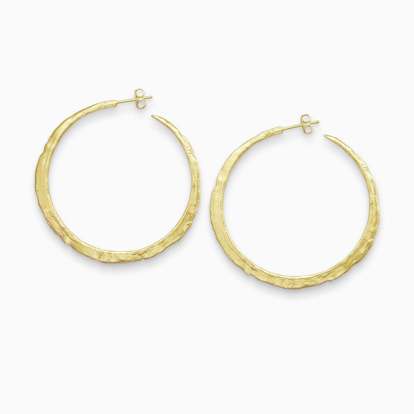 A pair of 18ct Fairtrade yellow gold round hoop earrings with a stud fastening. Organic texture and and tapering from bottom centre to the top. 55mm outside diameter.
