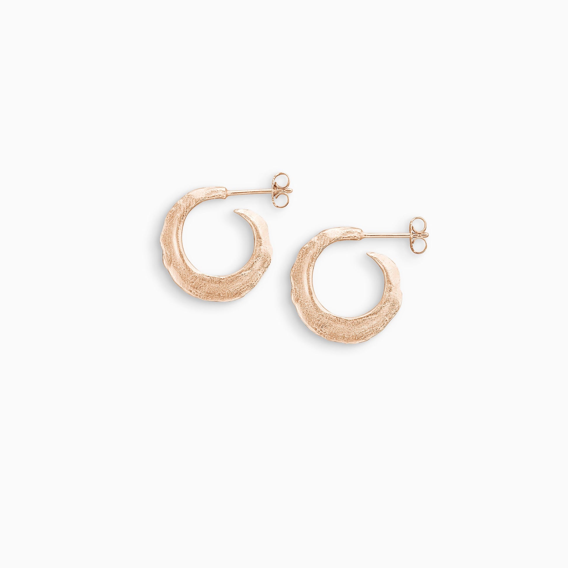 A pair of 18ct Fairtrade rose gold  round hoop earrings with a stud fastening. Organic texture and and tapering from bottom centre to the top. 22mm outside diameter.