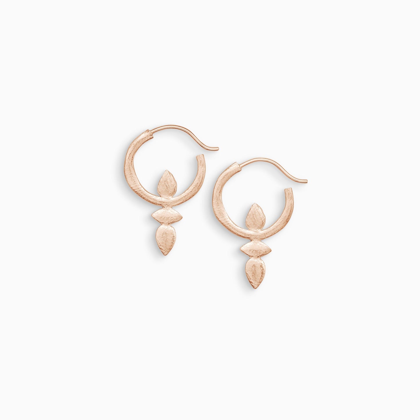 A pair of 18ct Fairtrade rose gold hoop earrings with a stud fastening. Small organic lozenge and teardrop shaped forms are attached below and inside the hoop. 18mm x 30mm 
