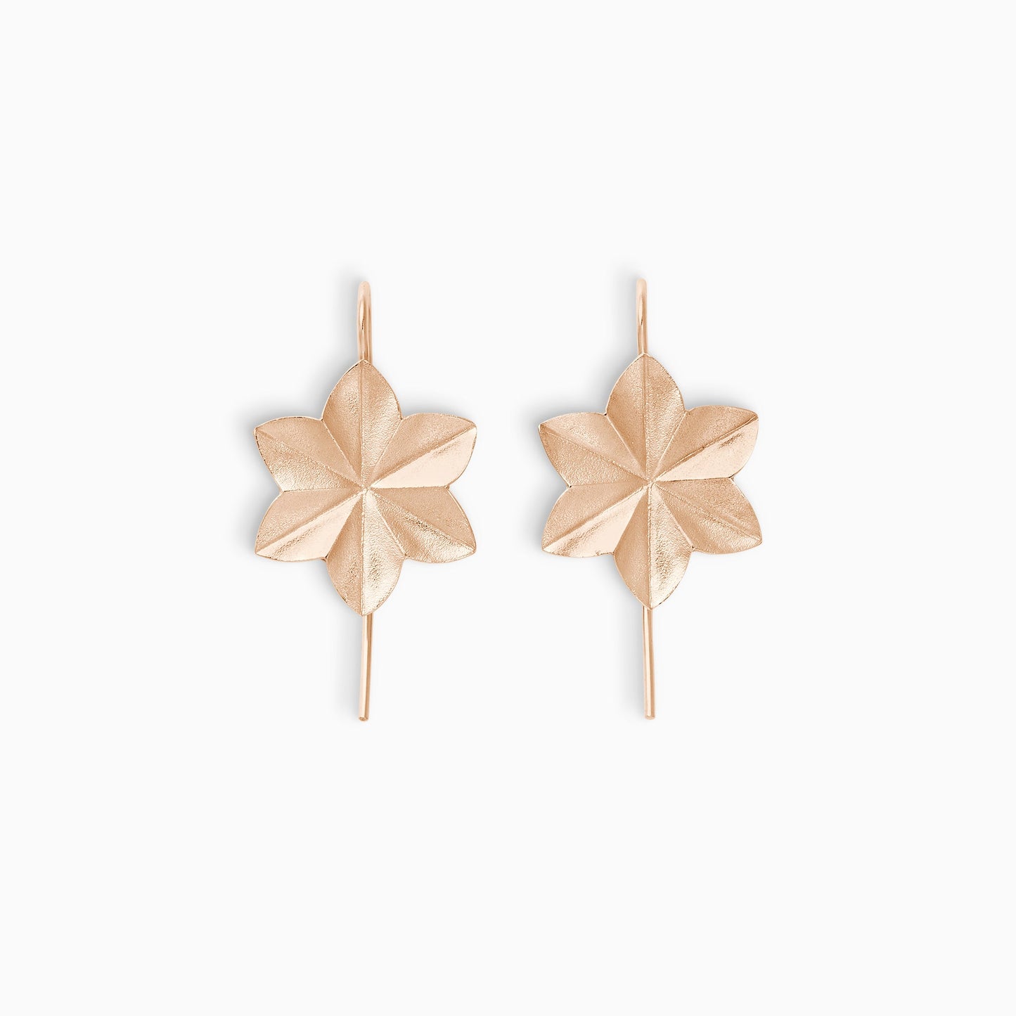 A pair of 18ct fairtrade rose gold lightly textured earrings in the shape of an origami folded 6 petal flower with a hook fastening. 38mm length, 18mm width.