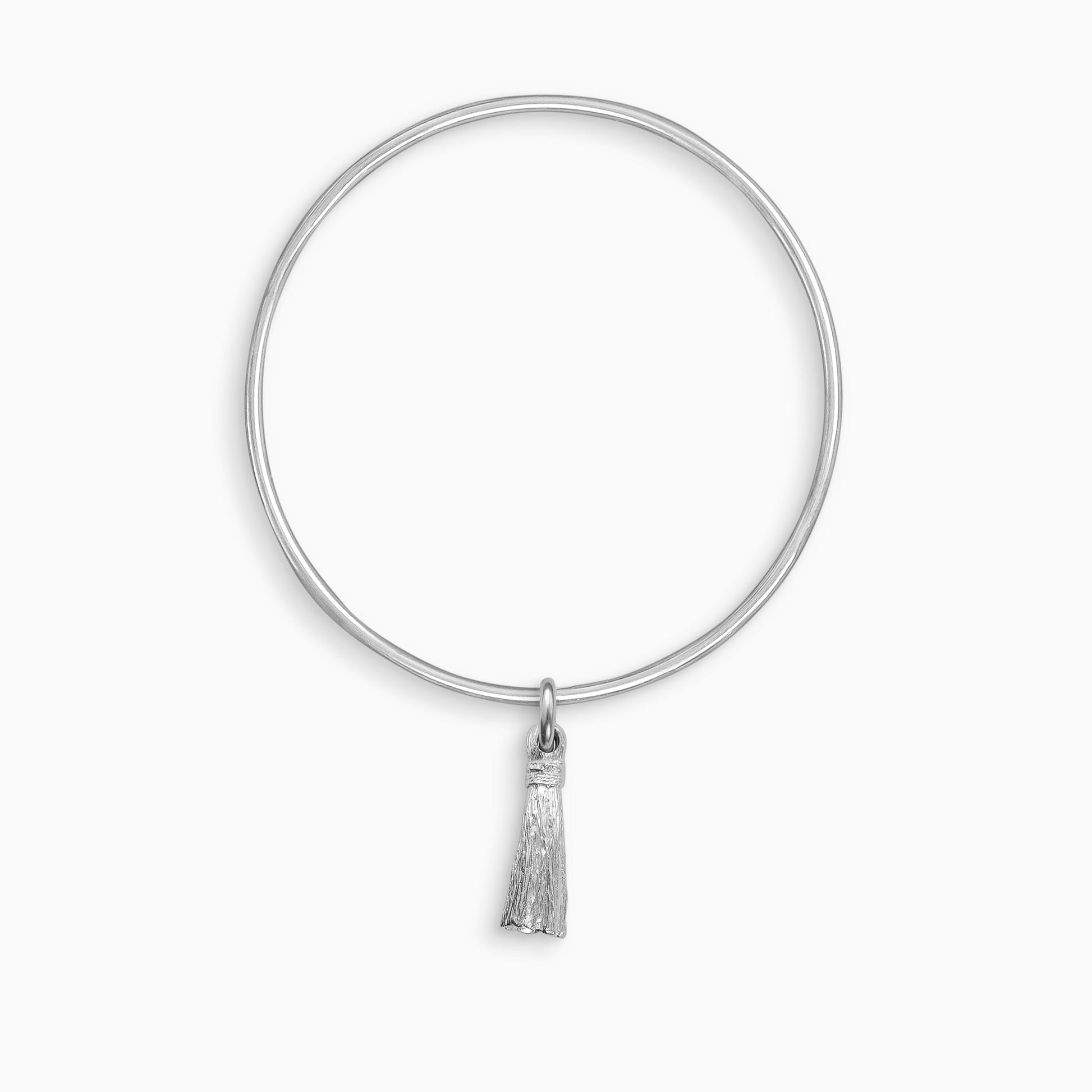 A recycled Silver Tassel charm, with the texture of an actual tassel, freely moving on a round wire bangle. Charm 25mm. Bangle 63mm inside diameter x 2mm round wire.