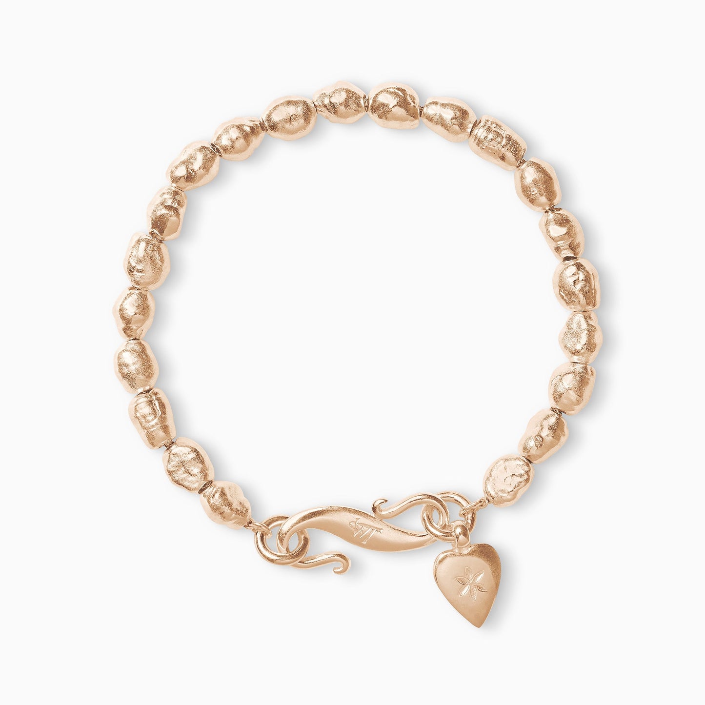 An 18ct Fairtrade rose gold bracelet of handmade irregular pearl shaped textured beads with a smooth heart shaped charm engraved with a 6 petal flower and our signature ’S’ clasp. Bracelet length 210mm. Beads varying approximately 8mm x 6mm.